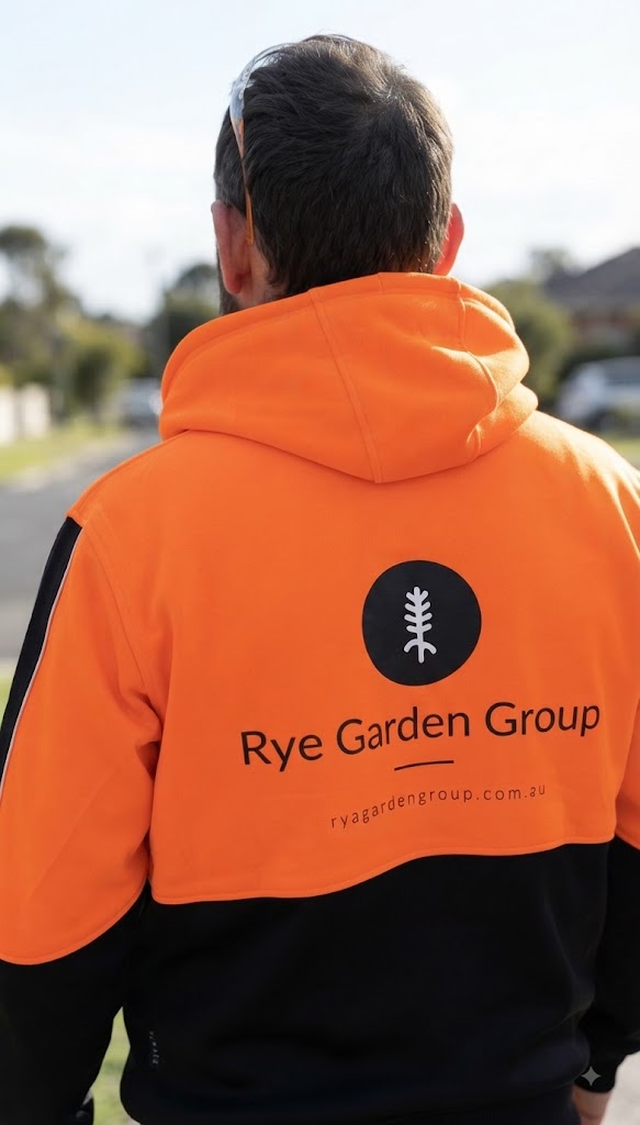 Rye Garden Group team member in branded hi-vis workwear on site
